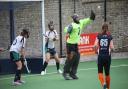 Emma Bentley and Jules Griffiths watch as Tracey Jago makes a save for St Ives.