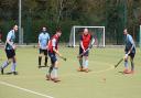 Father and son Luca and Iain Moore in bibs duel with Ben Seaber in the D during an intra-club friendly at St Neots Hockey Club.