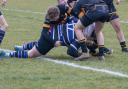 Four Oakham players fail to prevent St Ives centre John Paxton from scoring.