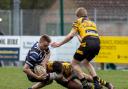 An Ely Tigers player makes a tackle on St Ives' flanker Jack Hickman in their Percy Walker Cup contest.