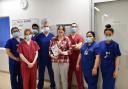 Sallie Crawley (centre) with Dr Will Davies (fourth from left) and members of the catheter lab and cardiology team at Royal Papworth Hospital.