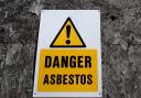 Stock image of an asbestos earning sign.