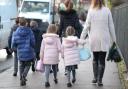 Stock photo of children walking to school.