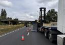 A lorry has shed its load on the A1 near St Neots.