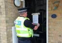 PC Sam Palmer putting up the closure order notice at the property