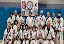 St Ives & Huntingdon students and instructors. Centre standing: Grand Master Khan. Trophy winners (left to right): Roger Clark, Zoe  Halliday, Maryam Islam, Alex Chapman, Henry Clark, Gavin McNally.