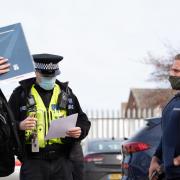 Police officers talking to gym owner Alex Lowndes outside Gainz Fitness and Strength.