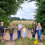 Children joined forces with the Alconbury Brook Flood Group to plant trees. (L to R: Kit, Clara, Darcy, Mia, Leela, and Elsa).