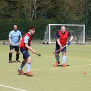 Father and son Luca and Iain Moore in bibs duel with Ben Seaber in the D during an intra-club friendly at St Neots Hockey Club.