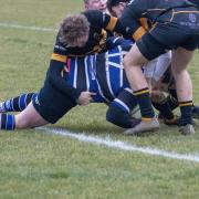 Four Oakham players fail to prevent St Ives centre John Paxton from scoring.