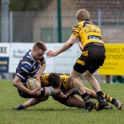 An Ely Tigers player makes a tackle on St Ives' flanker Jack Hickman in their Percy Walker Cup contest.