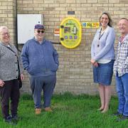 David Rolph and his sister Debbie Whitehead (L) have purchased a defibrillator for Somersham. They are pictured with Irene from Somersham Parish Council, and Debbie's Husband, Nigel Whitehead.