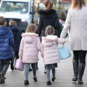 Stock photo of children walking to school.