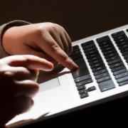 Stock image of a child on a laptop.