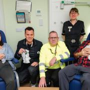 Dave Chambers (Salvation Army Lead Collector), Sabrina Kayser (Senior Sister), Mum Zoe with baby Huxley, and Anya Johnston (Tesco Cambridge Community Champion) at Addenbrookes Hospital.