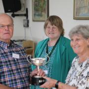 Club president Diane Briars presenting the winner's trophy to David Usher, looked on by show secretary Alison Gilbey.