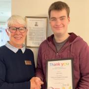 Josh Pace, 'Chief Can Crusher' for the Huntingdon Cromwell Rotary Club, with his certificate.