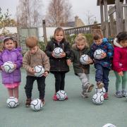 The children at Jemima House Day Nursery with their footballs.