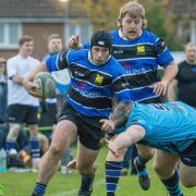 Rees Burns round the last defender to complete his hat-trick.