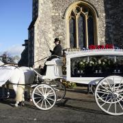 A horse-drawn carriage carrying the coffin of Liam Payne arrives for the funeral service of One Direction singer