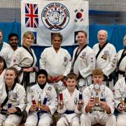 St Ives & Huntingdon students and instructors. Centre standing: Grand Master Khan. Trophy winners (left to right): Roger Clark, Zoe  Halliday, Maryam Islam, Alex Chapman, Henry Clark, Gavin McNally.