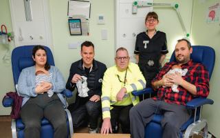 Dave Chambers (Salvation Army Lead Collector), Sabrina Kayser (Senior Sister), Mum Zoe with baby Huxley, and Anya Johnston (Tesco Cambridge Community Champion) at Addenbrookes Hospital.