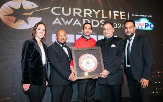 The Sultan Tandoori team receiving the award from Lord Karan Bilimoria, founder of Cobra Beer and awards host Camilla Tominey.