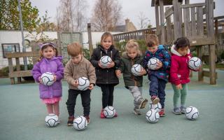 The children at Jemima House Day Nursery with their footballs.